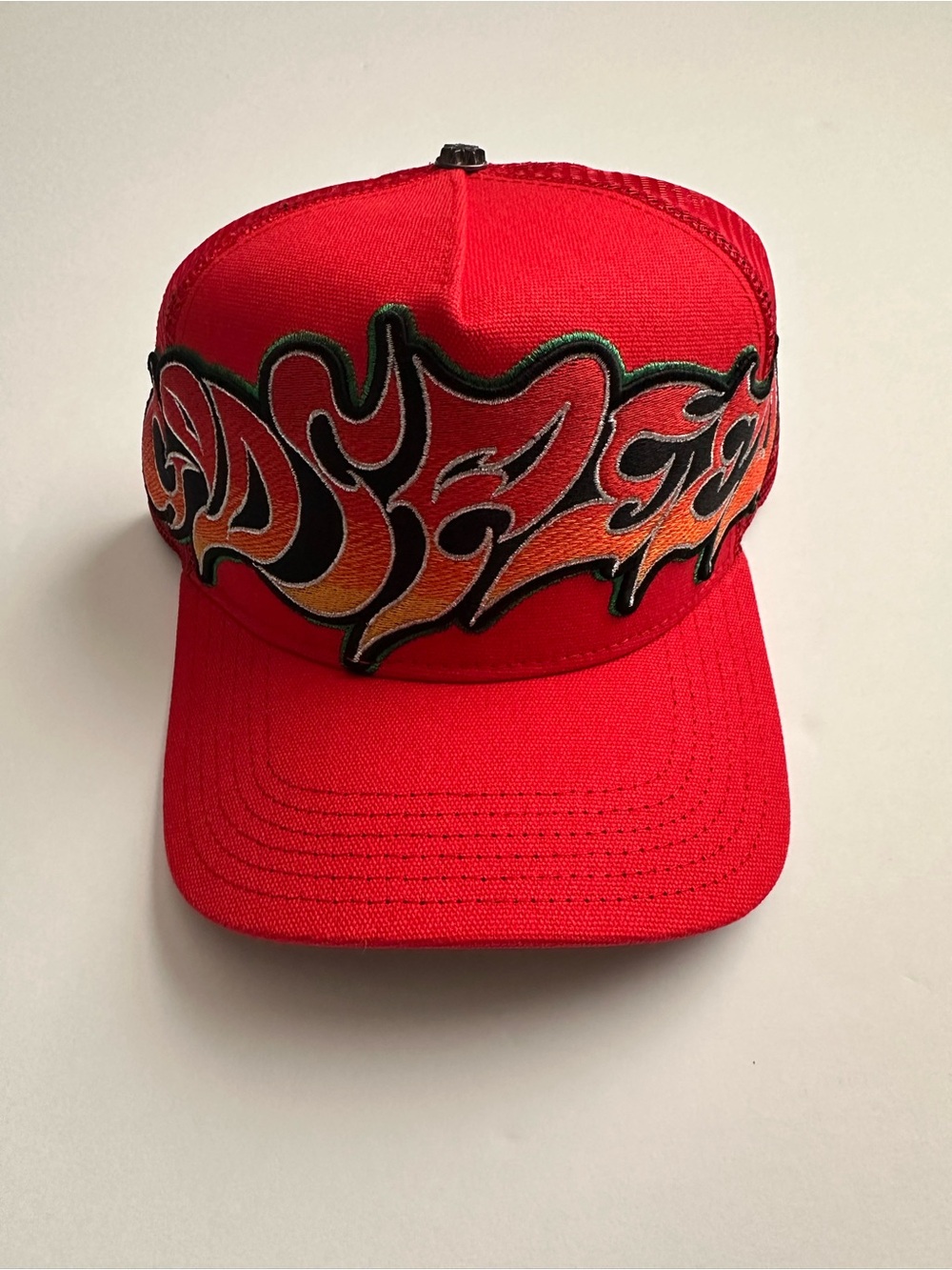 GODSPEED Neo Trucker Hat. Red Mesh with Green Sun Eye Patch.